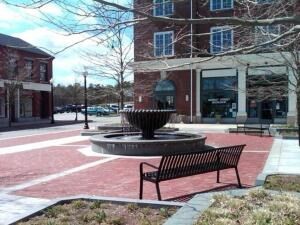 1 Upland Circle, Unit 1 Mashpee, MA 02649 - Photo 33 of 39 a view of a building with a bench in patio