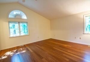 1 Upland Circle, Unit 1 Mashpee, MA 02649 - Photo 8 of 39 an empty room with wooden floor and windows