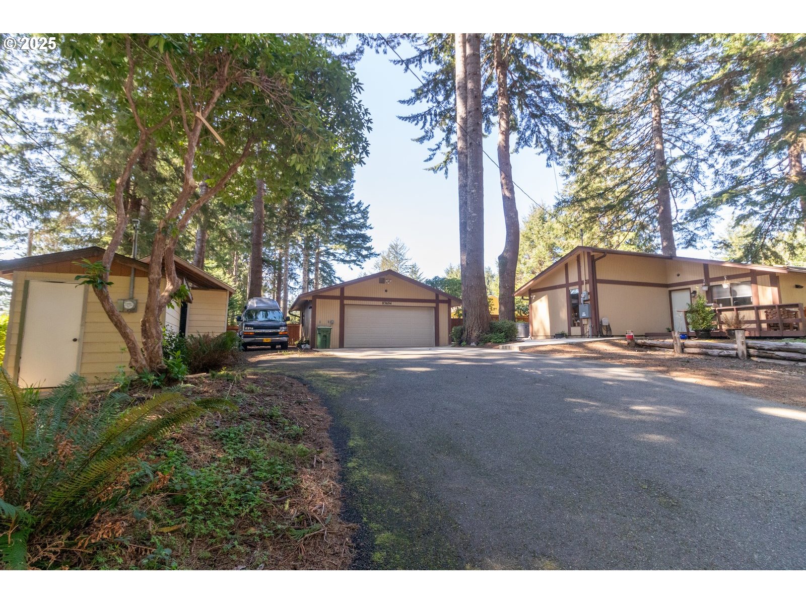 83694 Erhart Road Florence, OR 97439 - Photo 1 of 31 a view of a house with a tree and fence