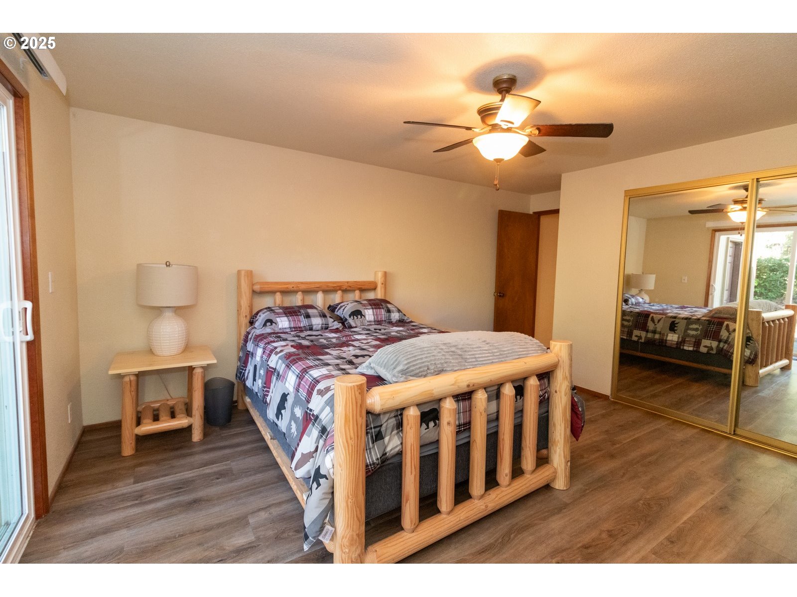 83694 Erhart Road Florence, OR 97439 - Photo 16 of 31 a bedroom with a bed and wooden floor