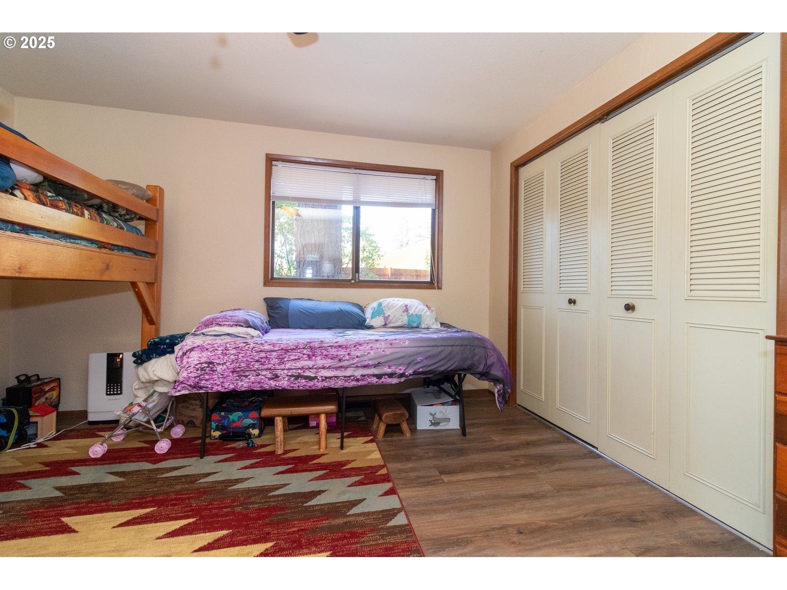 83694 Erhart Road Florence, OR 97439 - Photo 18 of 31 a spacious bedroom with a bed table and a window