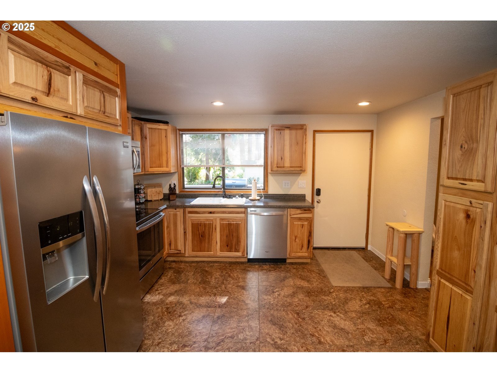 83694 Erhart Road Florence, OR 97439 - Photo 3 of 31 a kitchen with refrigerator cabinets and a sink