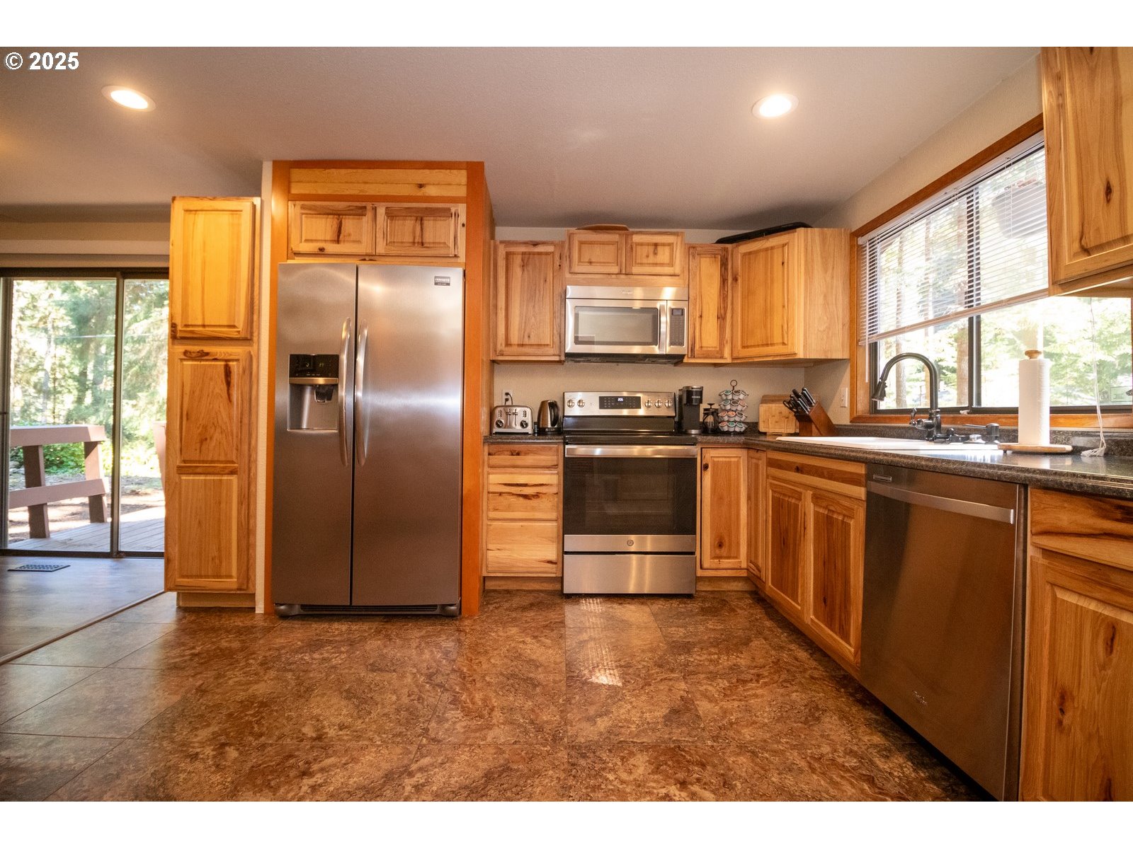 83694 Erhart Road Florence, OR 97439 - Photo 4 of 31 a kitchen with stainless steel appliances granite countertop a sink a stove and a refrigerator