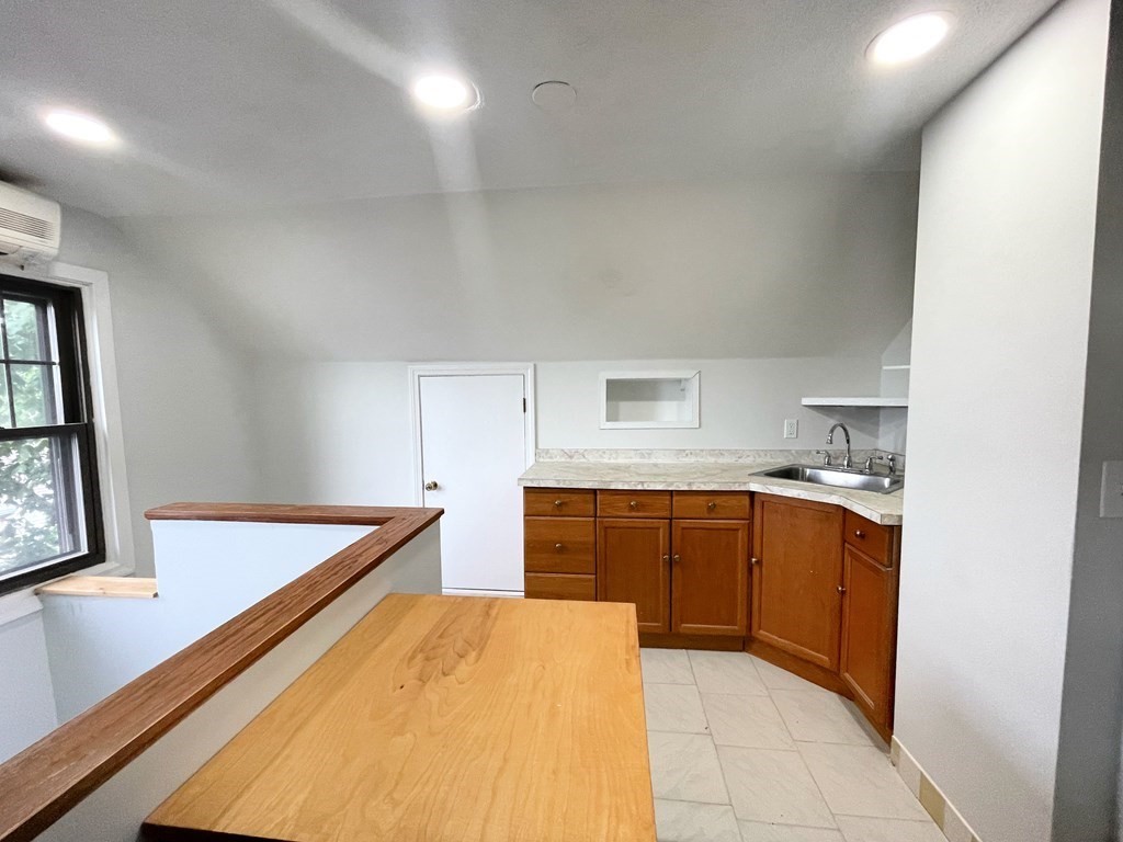 107 St Andrew Road, Unit 2A Boston, MA 02128 - Photo 1 of 1 a kitchen with sink a stove and cabinets