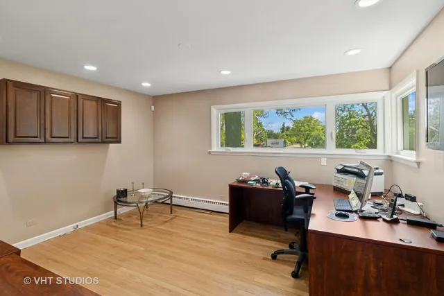 a view of a workspace with furniture and a window