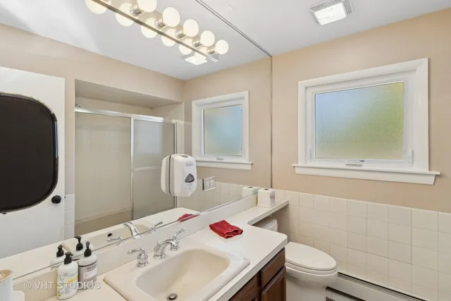 a bathroom with a sink toilet and shower