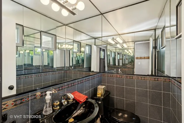 a bathroom with mirror and tiles