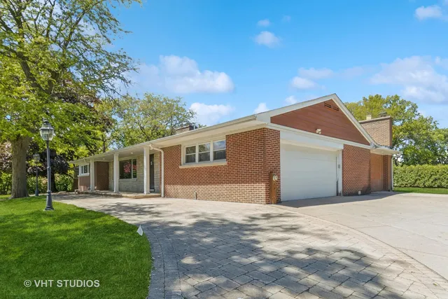 a front view of house with yard and trees