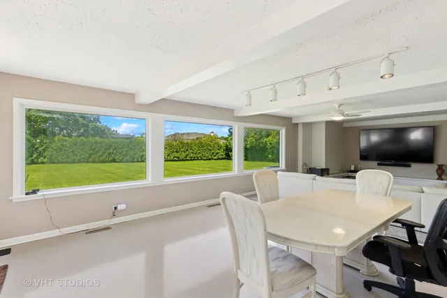 a view of a dining room with furniture window and outside view