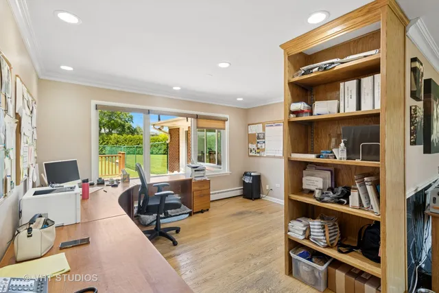 a living room with furniture hard wood floor and a book shelf