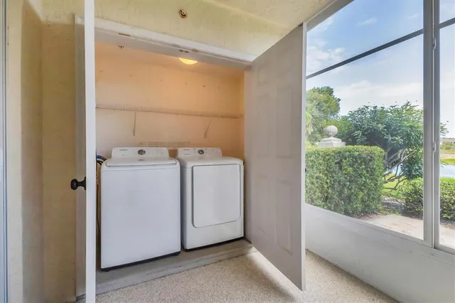 a view of a house with a yard and potted plants