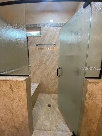 a bathroom with a shower and a mirror