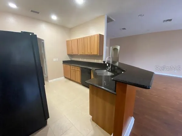 a kitchen with stainless steel appliances a sink stove and refrigerator