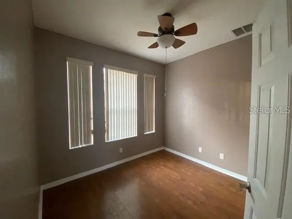 an empty room with a empty space and windows