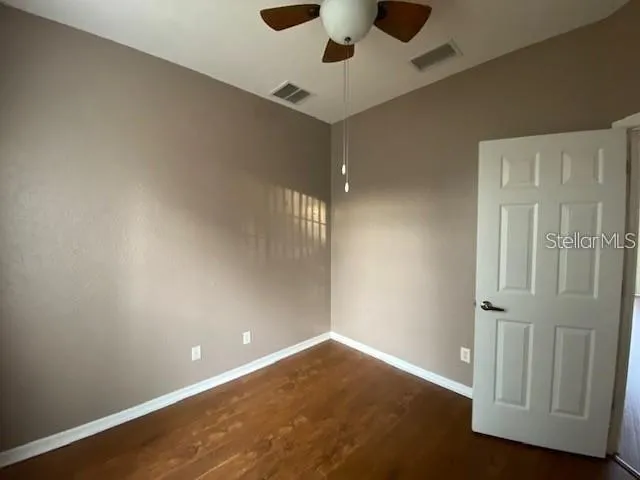 an empty room with wooden floor