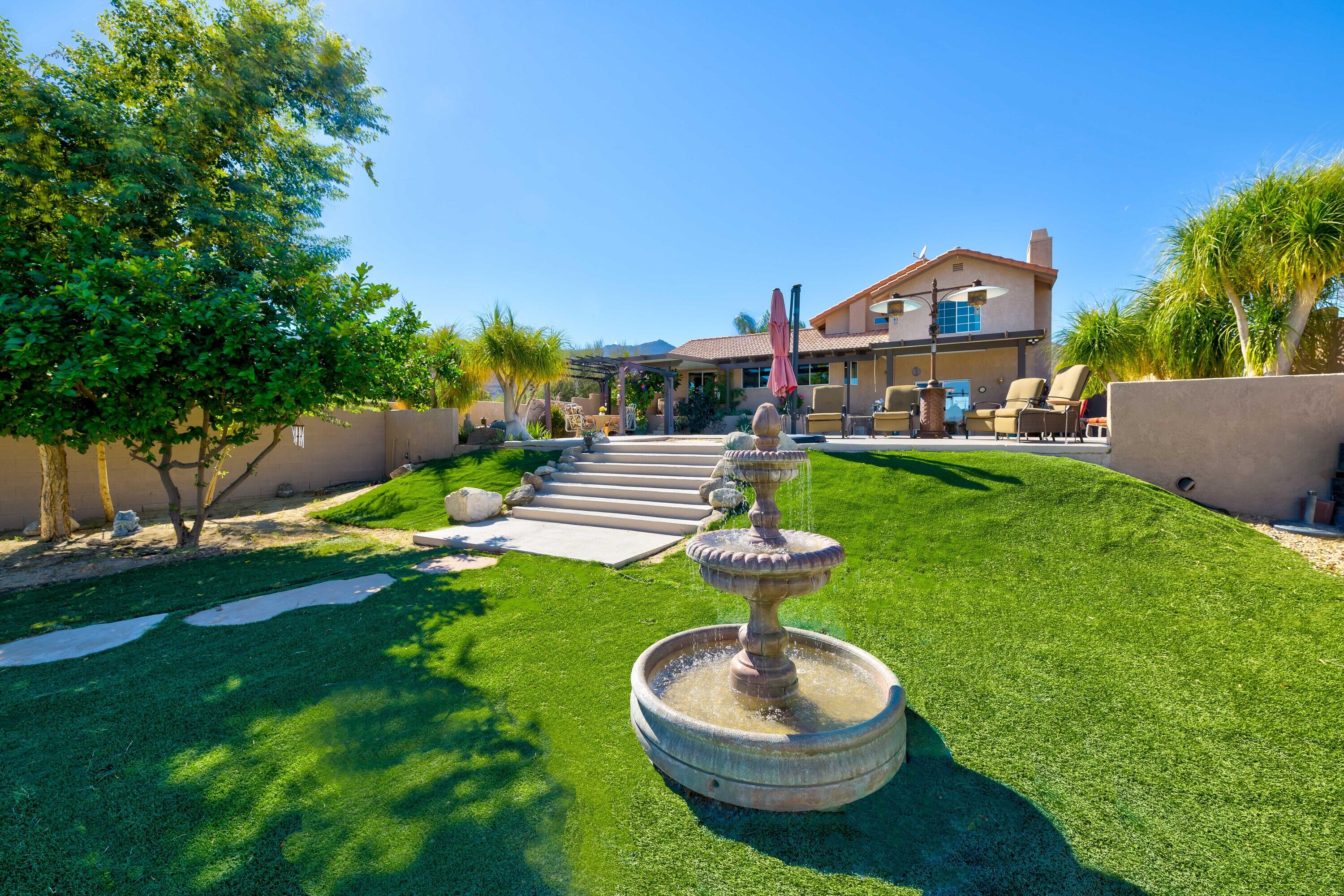 71750 Cholla Way Palm Desert, CA 92260 - Photo 34 of 42 a front view of a house with garden and trees