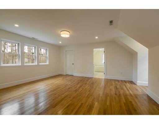 909 Lowell Road Concord, MA 01742 - Photo 19 of 28 a view of an empty room with wooden floor and windows