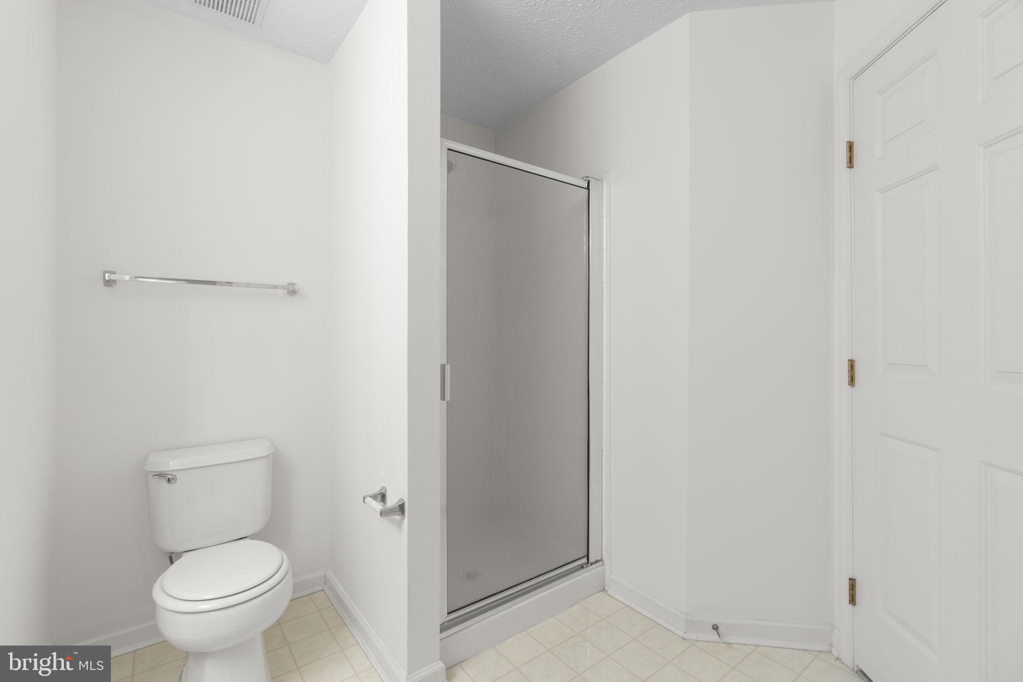 2444 Blue Spring Court, Unit 203 Odenton, MD 21113 - Photo 27 of 36 a white toilet sitting next to a shower
