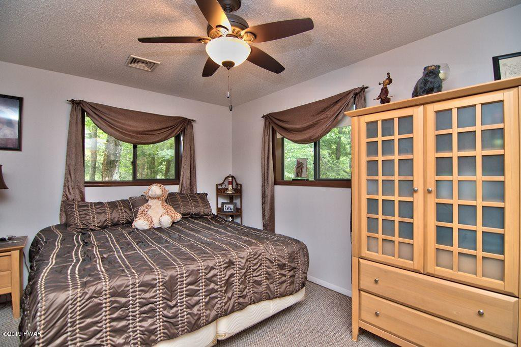 3151 Northgate Road Lake Ariel, PA 18436 - Photo 32 of 68 a bedroom with a large bed and a large window