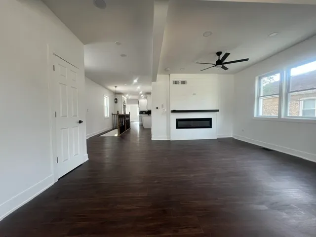 a room with furniture a flat screen tv and a wooden floor