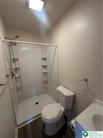 a bathroom with a toilet and a shower