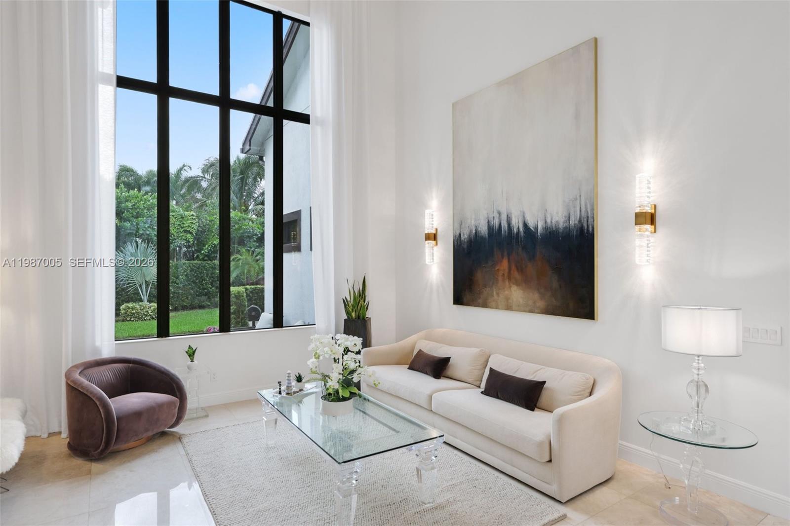 2751 Northwest 70th Boulevard Boca Raton, FL 33496 - Photo 12 of 90 a living room with furniture and a large window