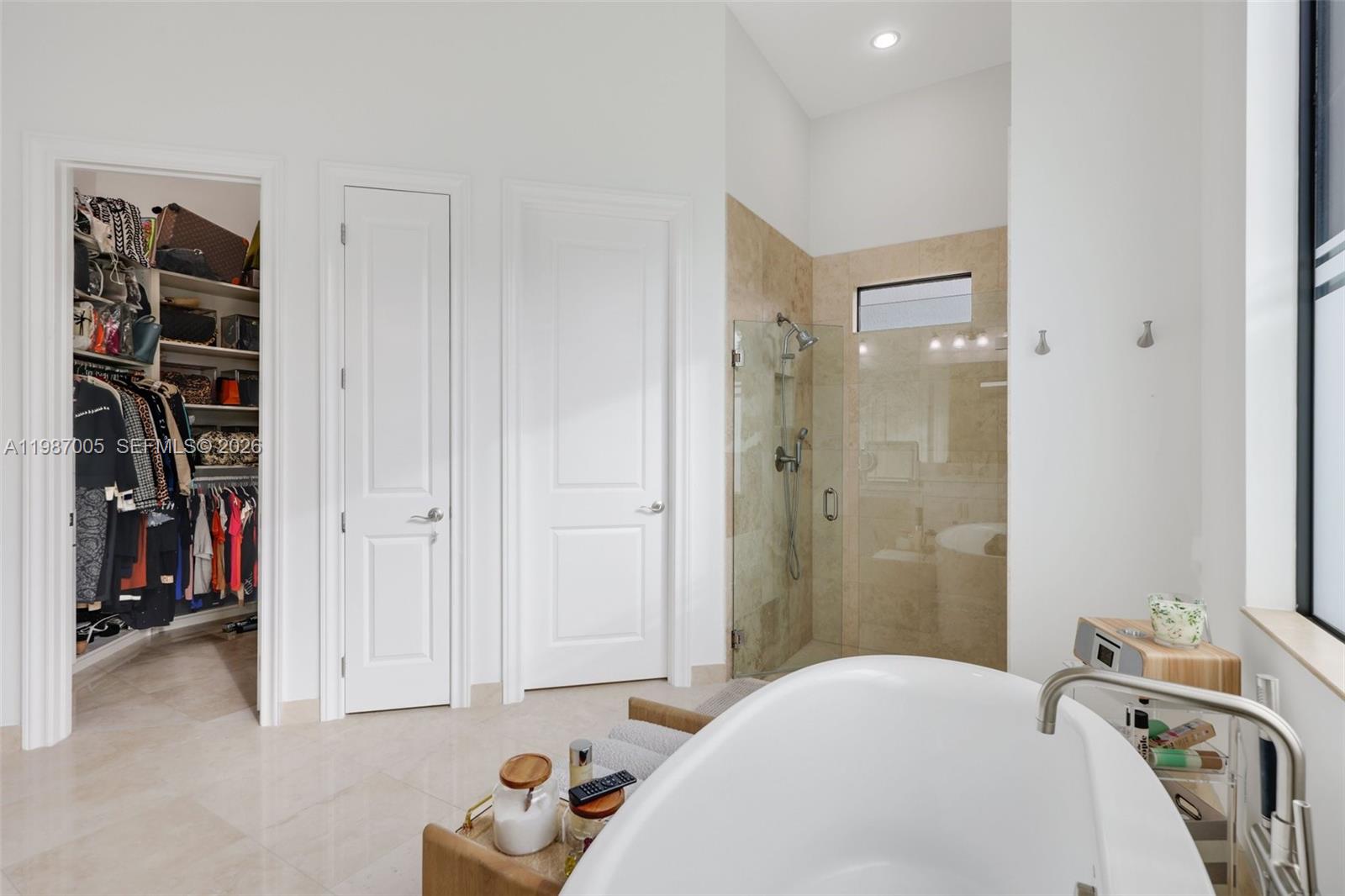 2751 Northwest 70th Boulevard Boca Raton, FL 33496 - Photo 17 of 90 a bedroom with a bed and a walk in closet