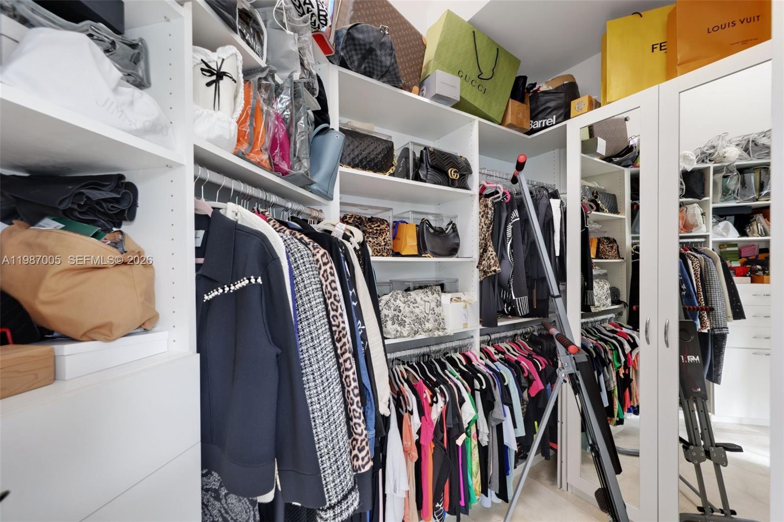2751 Northwest 70th Boulevard Boca Raton, FL 33496 - Photo 18 of 90 a view of walk in closet with clothes and shoes