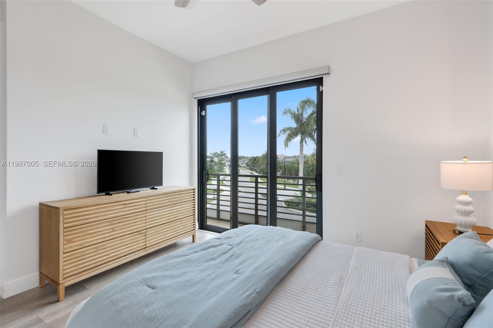 2751 Northwest 70th Boulevard Boca Raton, FL 33496 - Photo 24 of 90 a bedroom with a bed and a flat screen tv