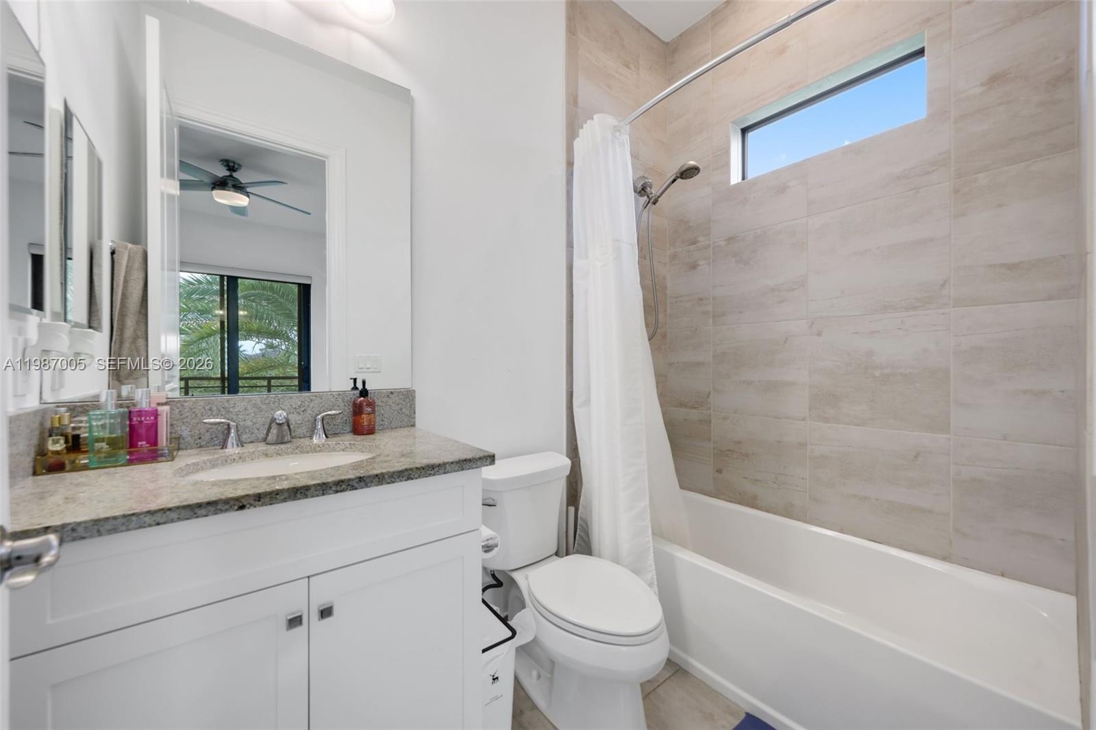 2751 Northwest 70th Boulevard Boca Raton, FL 33496 - Photo 28 of 90 a bathroom with a granite countertop sink toilet mirror and bathtub