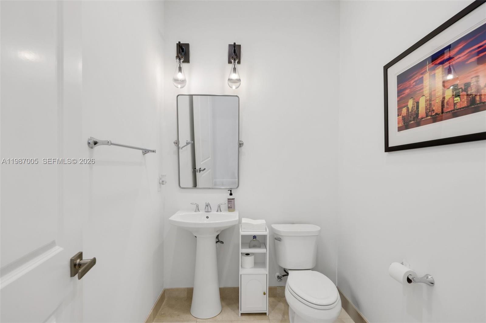 2751 Northwest 70th Boulevard Boca Raton, FL 33496 - Photo 38 of 90 a bathroom with a toilet sink and mirror