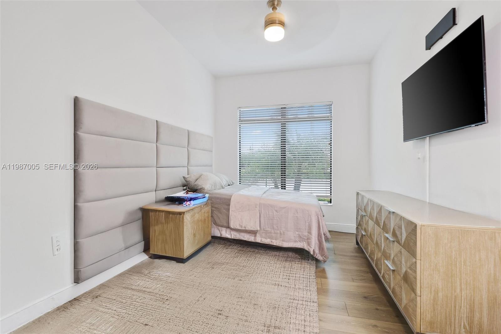 2751 Northwest 70th Boulevard Boca Raton, FL 33496 - Photo 43 of 90 a room with a bed and flat screen tv