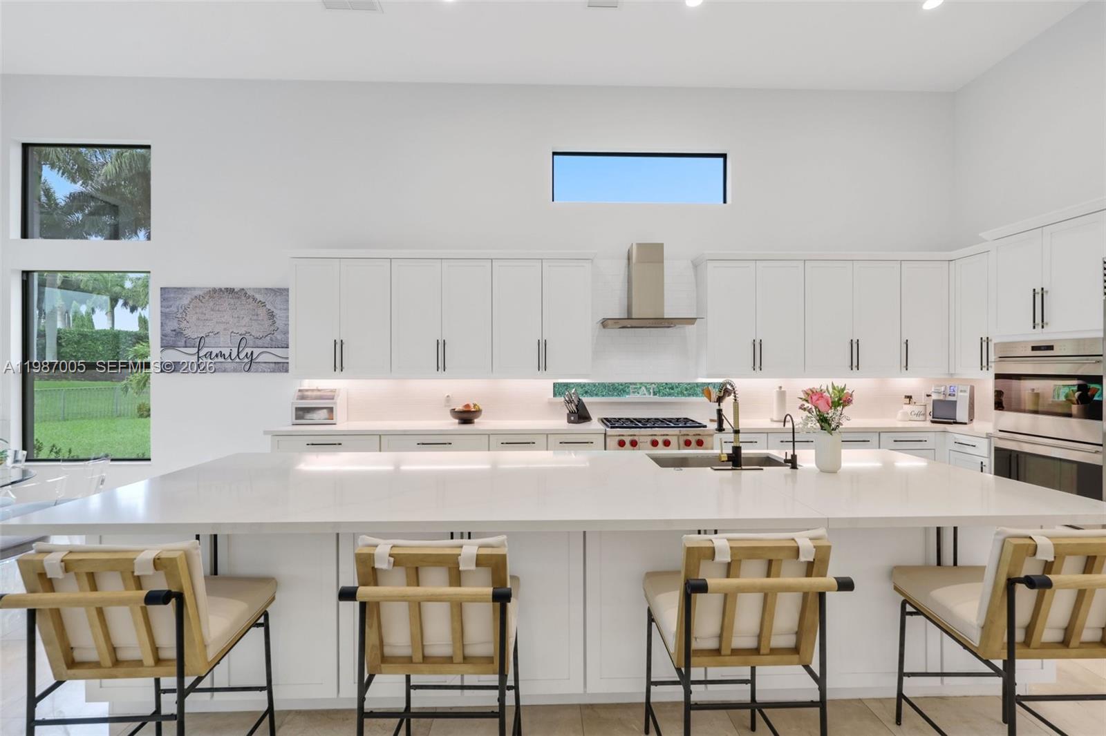 2751 Northwest 70th Boulevard Boca Raton, FL 33496 - Photo 51 of 90 a kitchen with stainless steel appliances a table chairs and a refrigerator