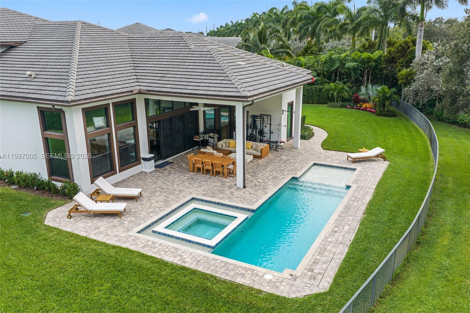 2751 Northwest 70th Boulevard Boca Raton, FL 33496 - Photo 63 of 90 a view of a house with pool and a yard