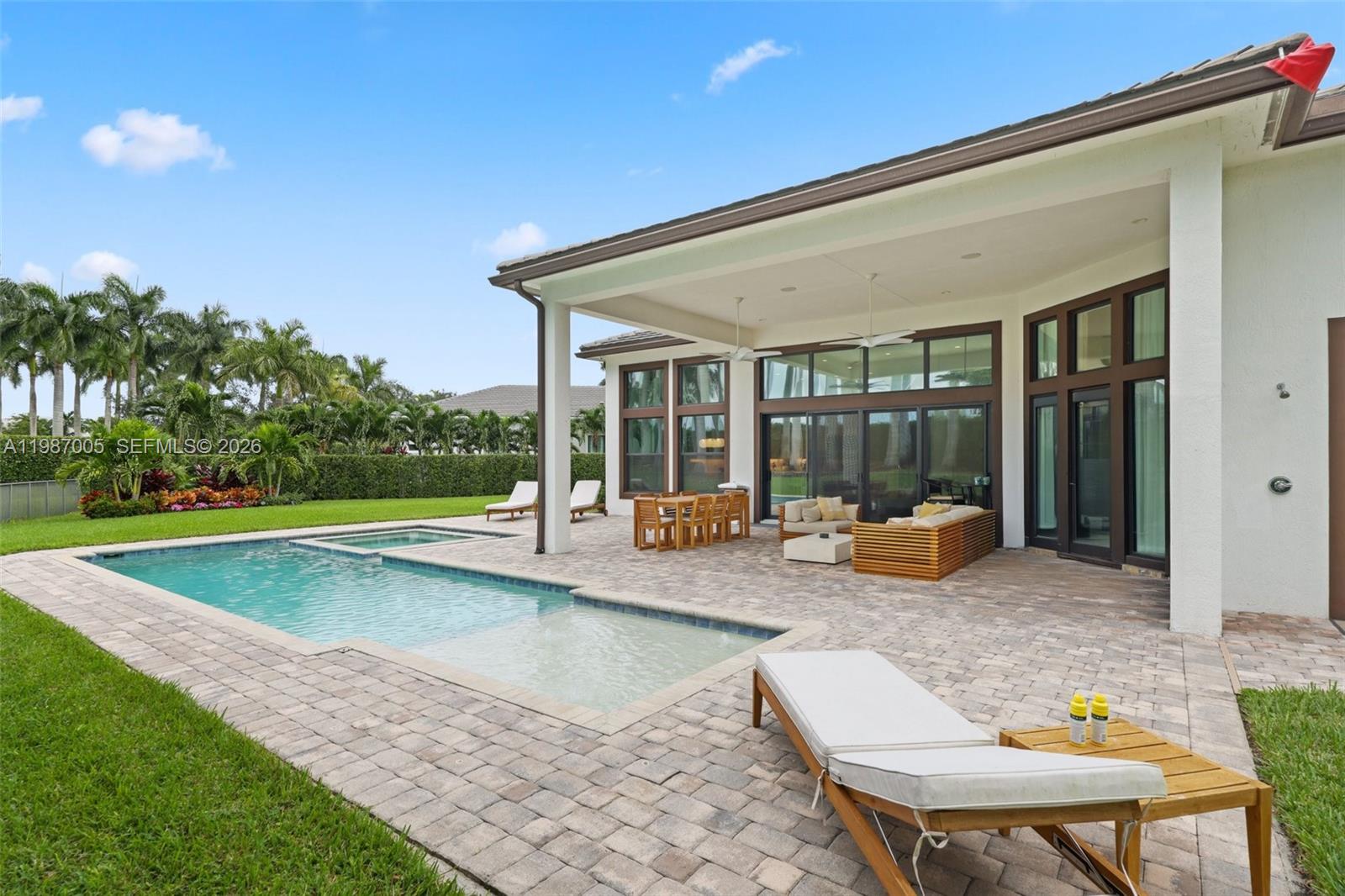 2751 Northwest 70th Boulevard Boca Raton, FL 33496 - Photo 69 of 90 a view of a house with swimming pool and sitting area