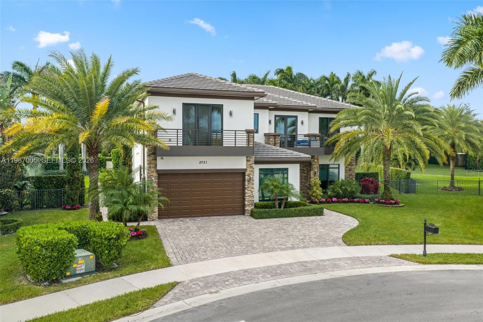 2751 Northwest 70th Boulevard Boca Raton, FL 33496 - Photo 81 of 90 a front view of a house with a yard and potted plants