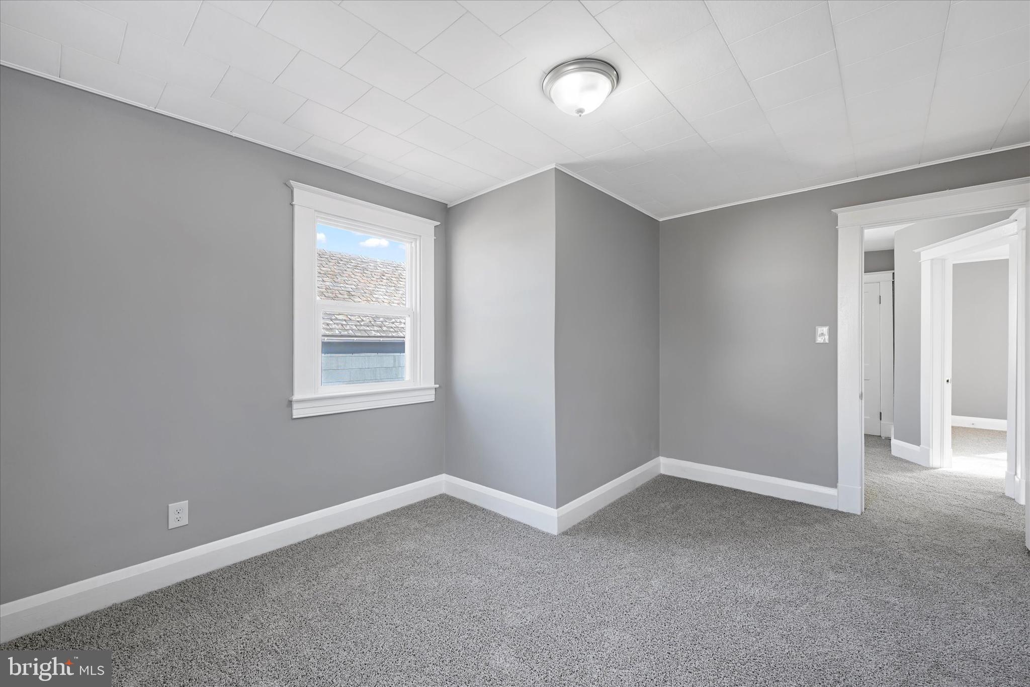 6113 Sefton Avenue Baltimore, MD 21214 - Photo 19 of 25 a view of an empty room with a window