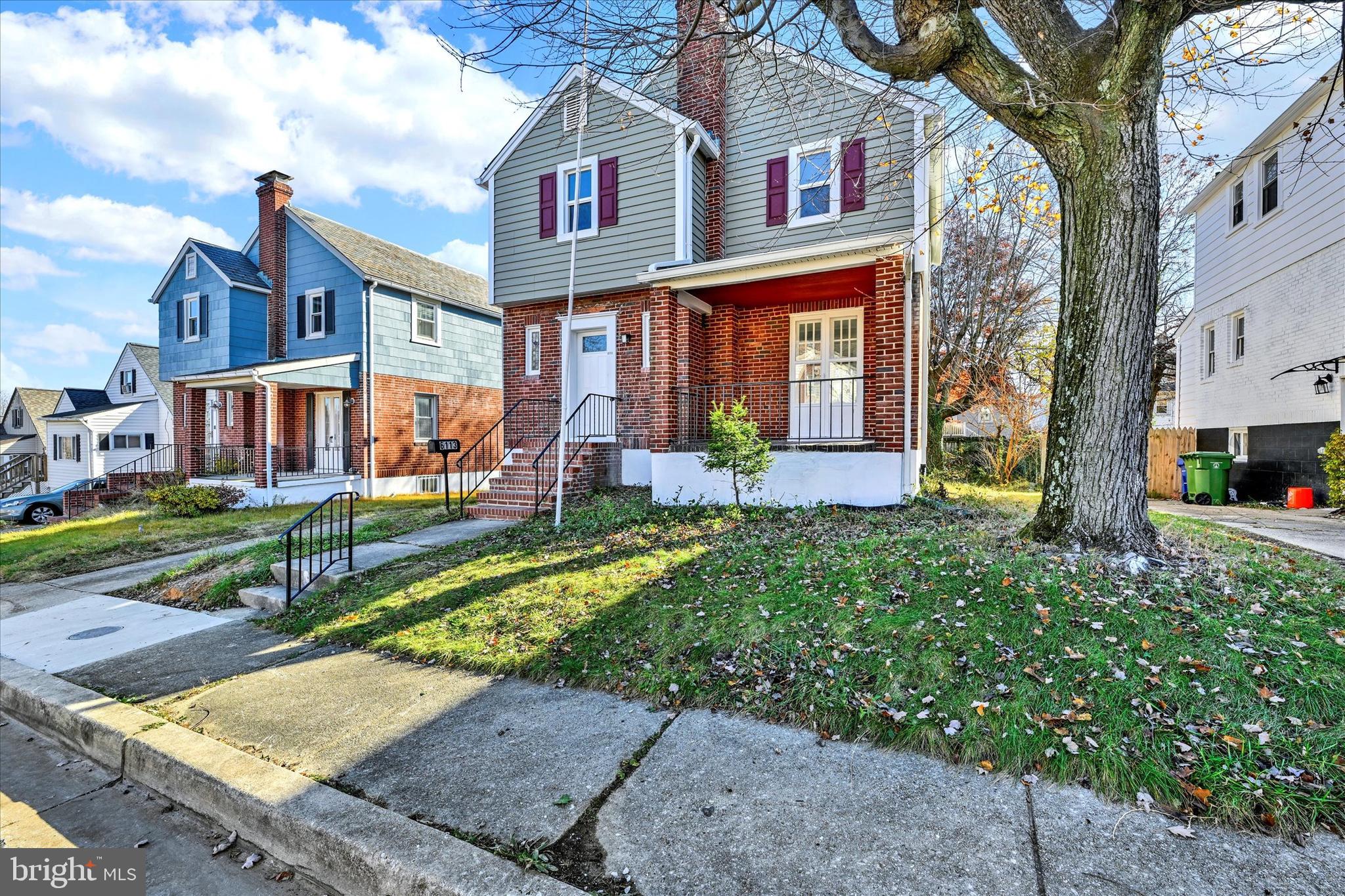 6113 Sefton Avenue Baltimore, MD 21214 - Photo 2 of 25 a front view of a house with garden