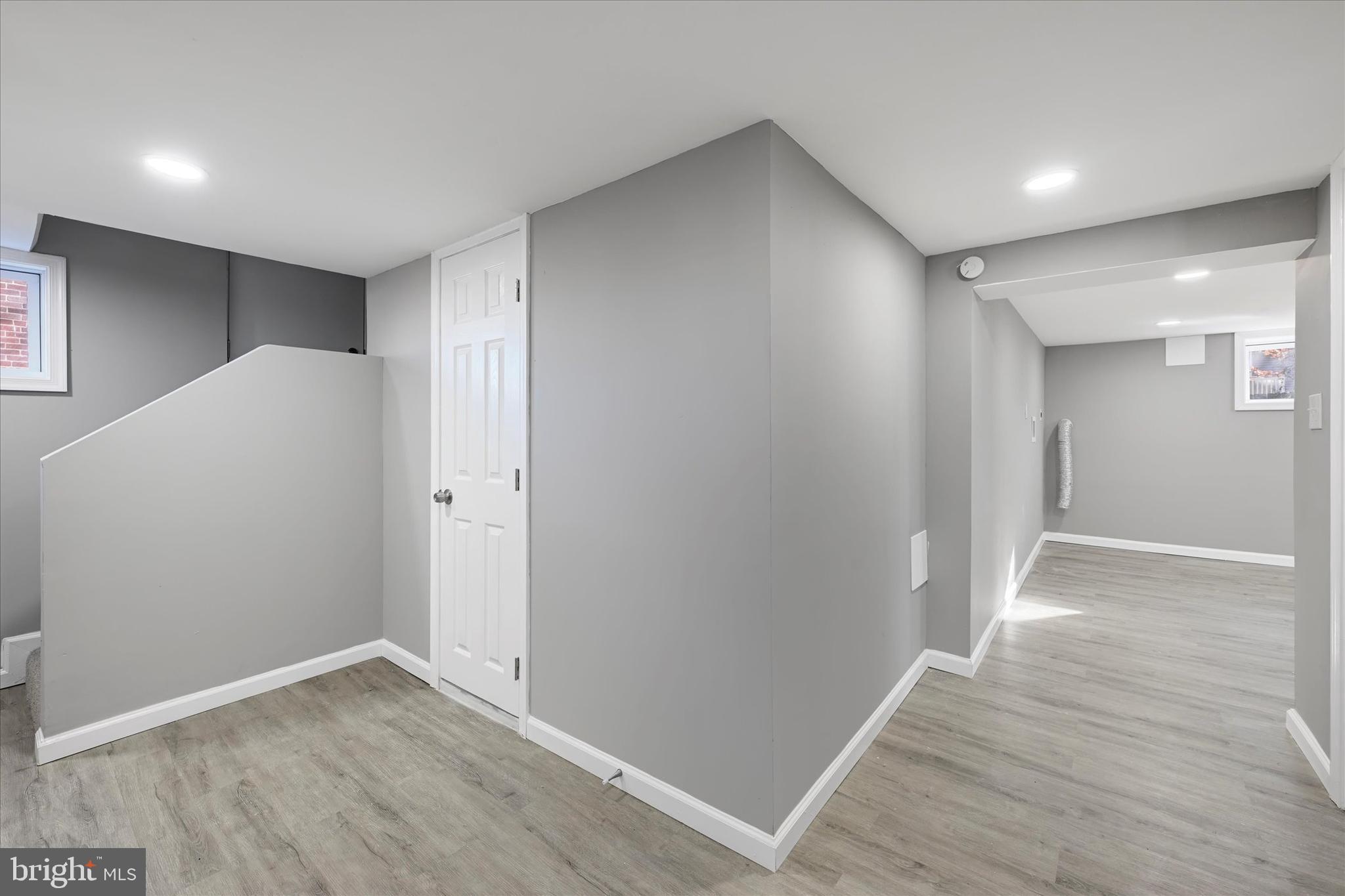 6113 Sefton Avenue Baltimore, MD 21214 - Photo 21 of 25 a view of an empty room with wooden floor