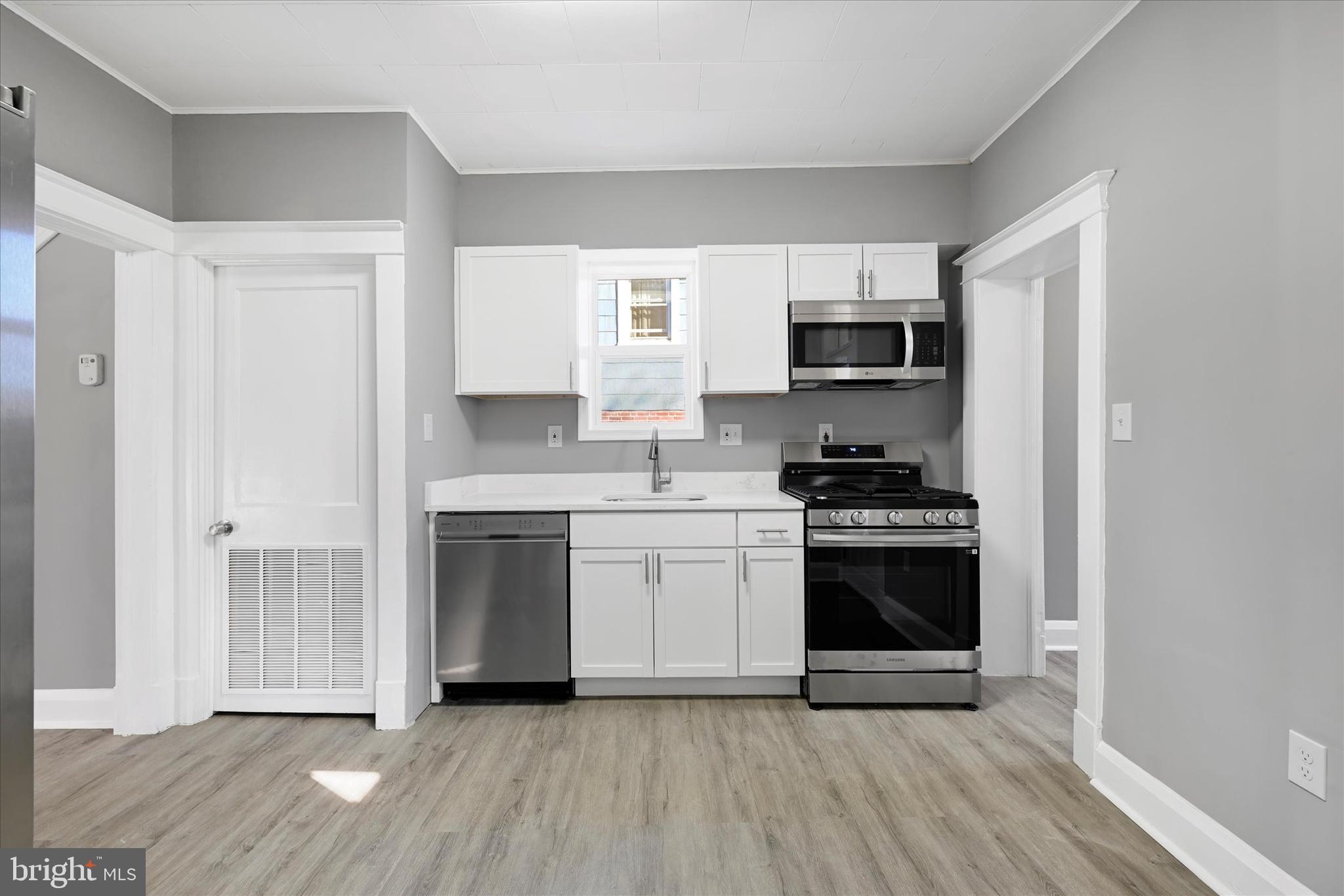 6113 Sefton Avenue Baltimore, MD 21214 - Photo 9 of 25 a kitchen with granite countertop a stove top oven and sink