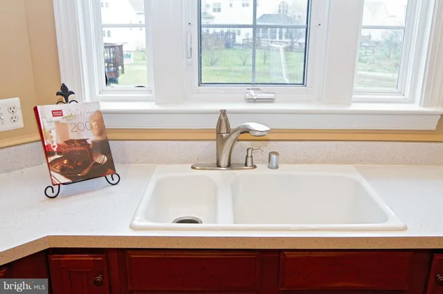 a bathroom with a bathtub and next to a window