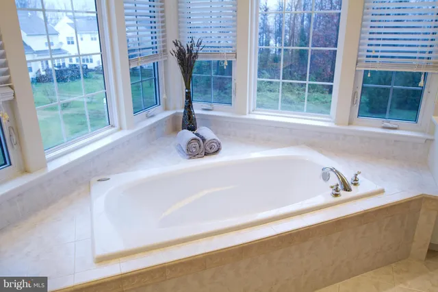 a bath tub sitting next to a window