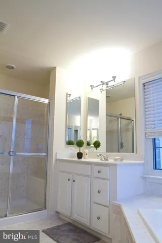 a bathroom with a granite countertop sink mirror and double