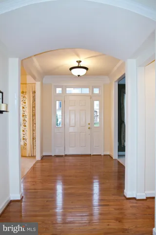 a view of an room with wooden floor and a window