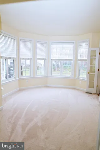 an empty room with windows and entrance