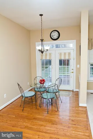 a view of a dining room with furniture wooden floor and fan