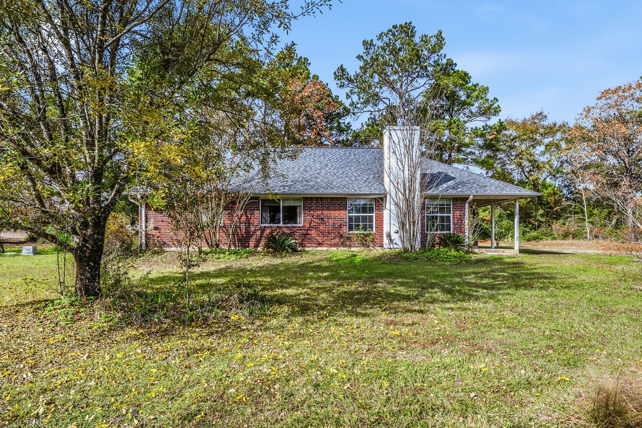 691 Bishop Road Huntsville, TX 77320 - Photo 31 of 32 a front view of a house with a garden