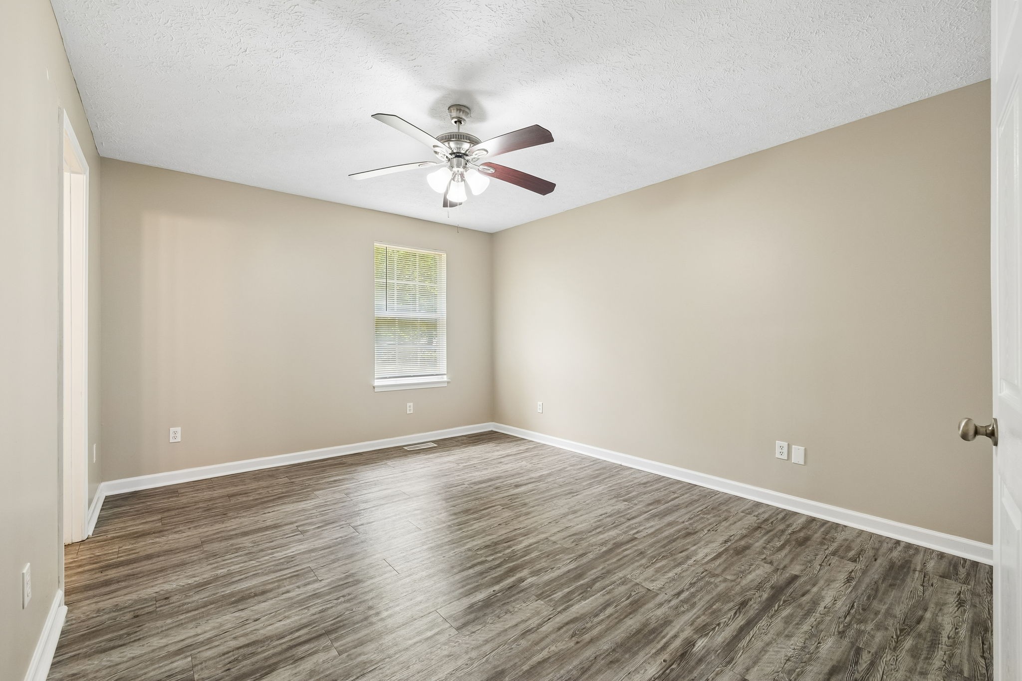511 Hayes Street Springfield, TN 37172 - Photo 17 of 26 a view of an empty room with chandelier fan and wooden floor
