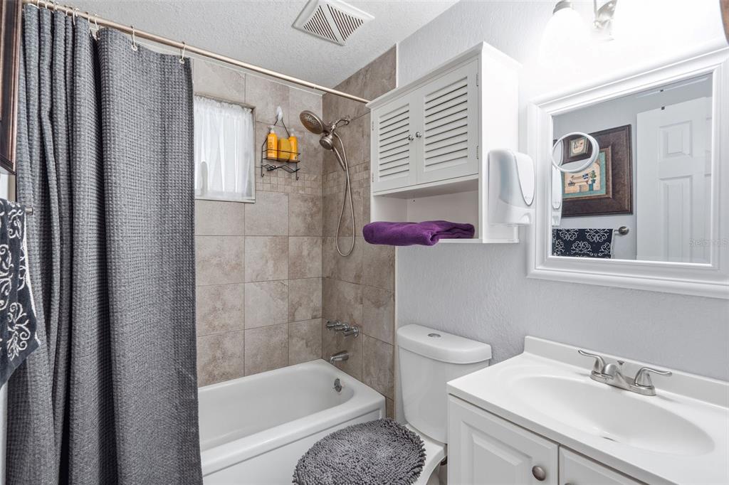 9381 Rosa Street Spring Hill, FL 34608 - Photo 11 of 26 a bathroom with a sink toilet and shower
