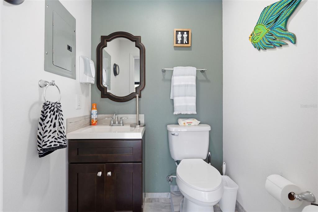 9381 Rosa Street Spring Hill, FL 34608 - Photo 17 of 26 a bathroom with a toilet sink vanity and mirror